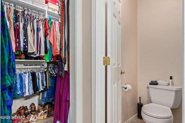 bathroom featuring toilet and tile patterned floors