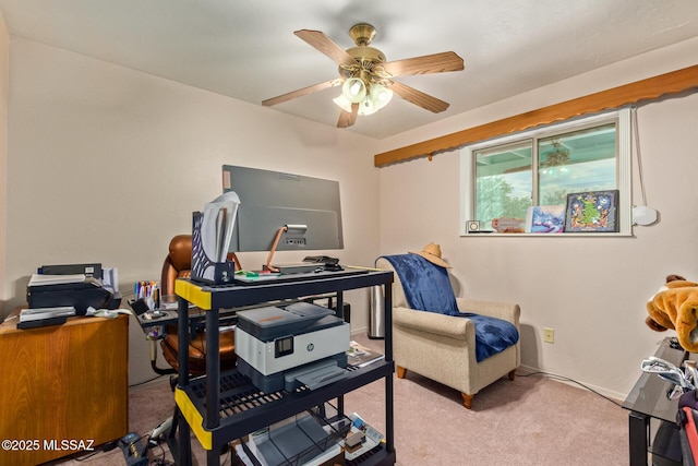 carpeted office featuring ceiling fan