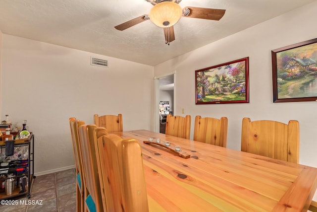 tiled dining area featuring ceiling fan