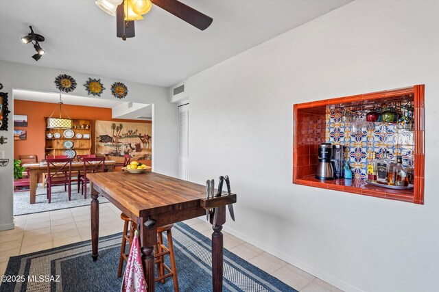 tiled dining room with ceiling fan