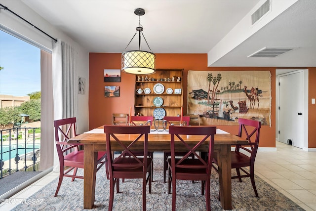 dining room with tile patterned floors and a healthy amount of sunlight