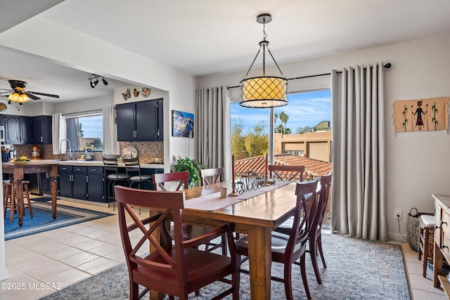 tiled dining area featuring sink, plenty of natural light, and ceiling fan