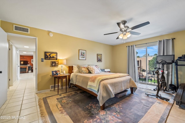 tiled bedroom featuring ceiling fan and access to exterior