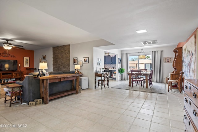 living room featuring ceiling fan and light tile patterned floors