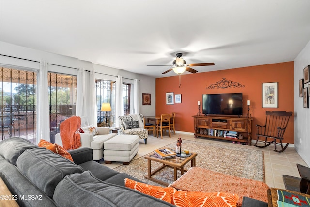 living room with ceiling fan and light tile patterned floors