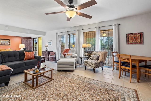 tiled living room featuring ceiling fan and a wealth of natural light