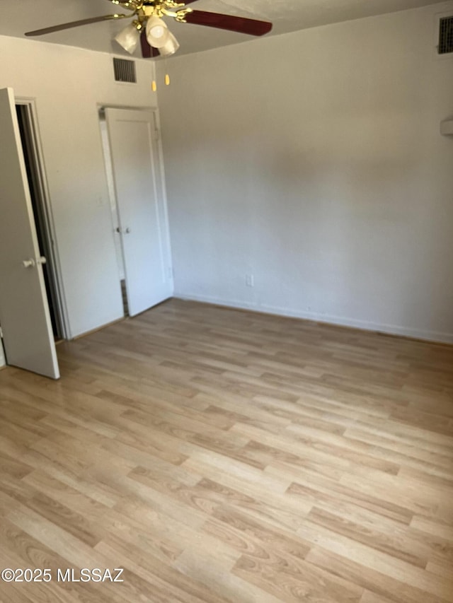 spare room featuring light hardwood / wood-style flooring and ceiling fan