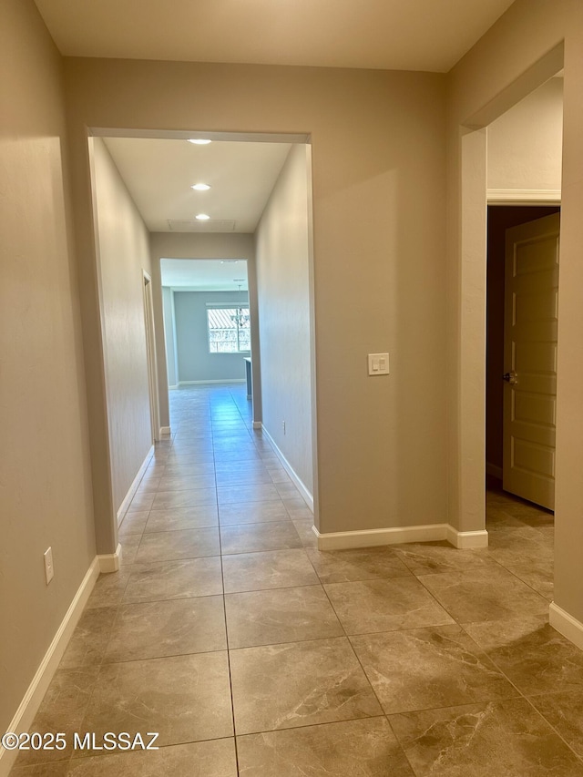hall featuring baseboards