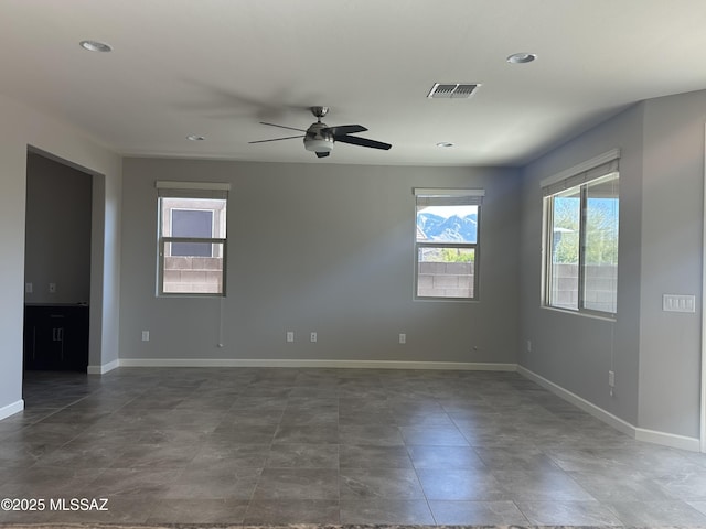 empty room featuring baseboards, visible vents, ceiling fan, and recessed lighting