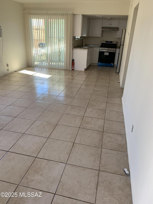 kitchen featuring appliances with stainless steel finishes, light tile patterned floors, and sink