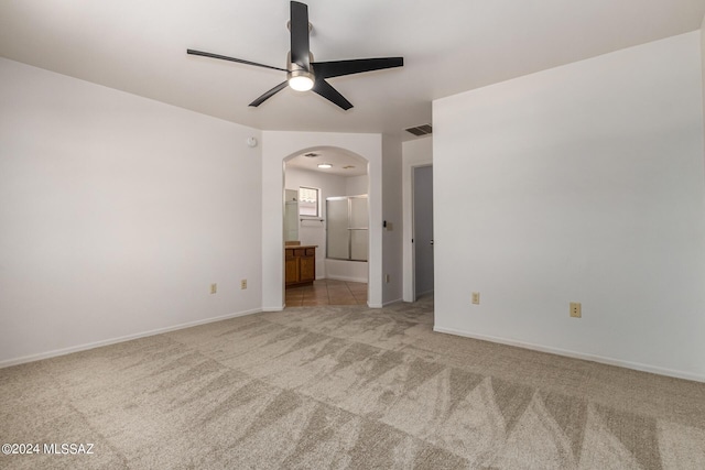 carpeted empty room featuring ceiling fan