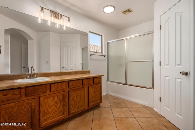 bathroom with shower / bath combination with glass door, vanity, and tile patterned floors