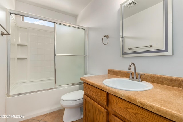 full bathroom with tile patterned floors, vanity, enclosed tub / shower combo, and toilet