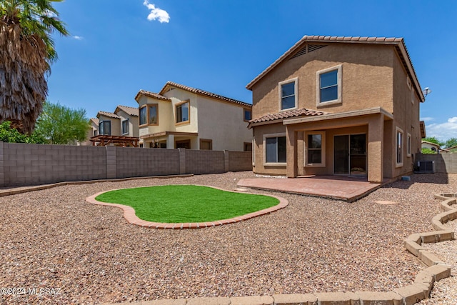 rear view of house with cooling unit and a patio