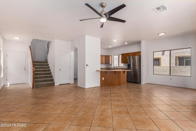 kitchen featuring ceiling fan, sink, light tile patterned flooring, and stainless steel refrigerator with ice dispenser