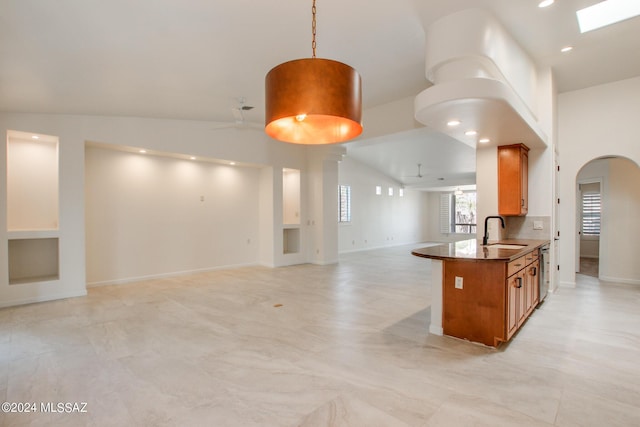 kitchen featuring kitchen peninsula, ceiling fan, sink, dishwasher, and hanging light fixtures