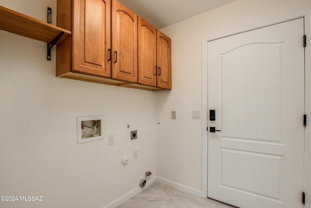 laundry room featuring hookup for an electric dryer, hookup for a washing machine, cabinets, light tile patterned floors, and hookup for a gas dryer