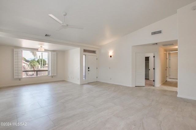 empty room with ceiling fan and lofted ceiling