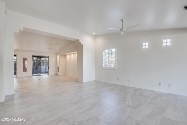 spare room featuring vaulted ceiling, a wealth of natural light, and ceiling fan