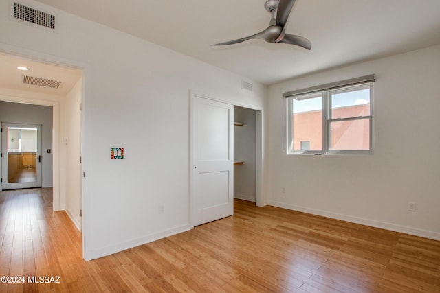 unfurnished bedroom with ceiling fan and light hardwood / wood-style floors