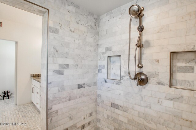 bathroom featuring vanity and tiled shower