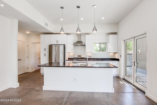 kitchen featuring appliances with stainless steel finishes, concrete floors, a kitchen island with sink, and wall chimney exhaust hood