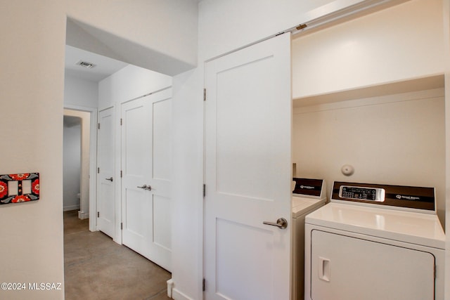 laundry room with washing machine and clothes dryer