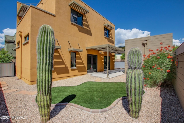 rear view of property featuring a patio