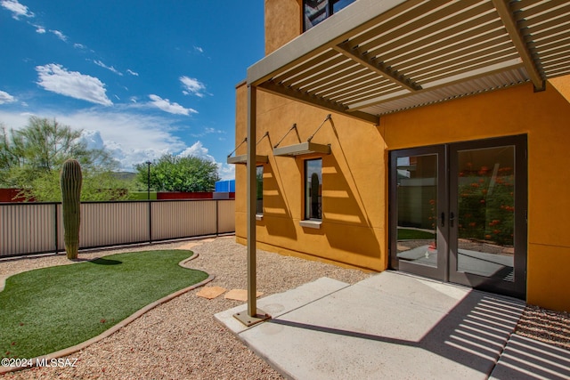 view of patio with french doors and a pergola