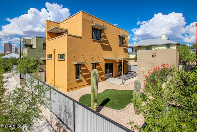 rear view of property featuring a patio