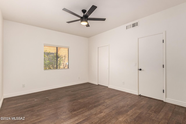 unfurnished bedroom with ceiling fan and dark hardwood / wood-style floors