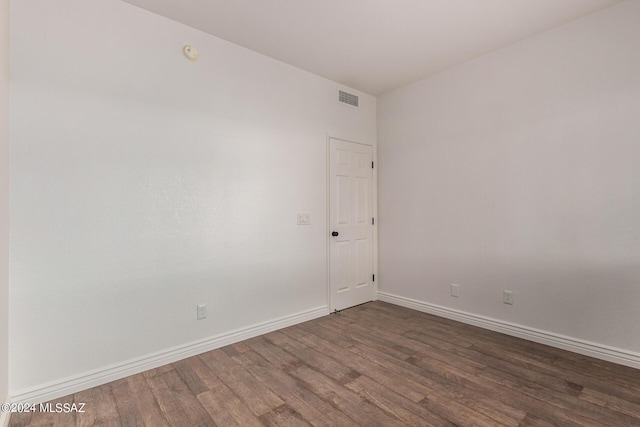 spare room with dark wood-type flooring