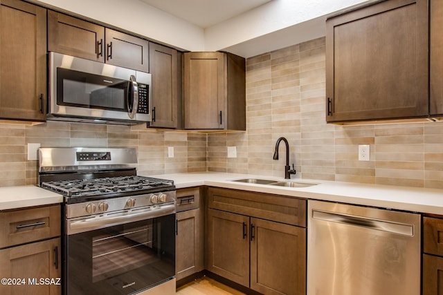 kitchen with stainless steel appliances, tasteful backsplash, and sink