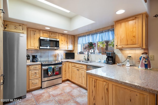 kitchen featuring stainless steel appliances, sink, light tile patterned floors, tasteful backsplash, and light stone countertops