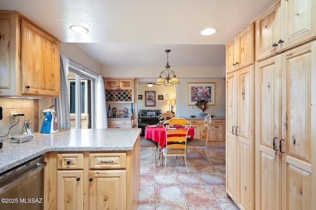 kitchen with dishwasher, pendant lighting, light brown cabinetry, tasteful backsplash, and light tile patterned flooring