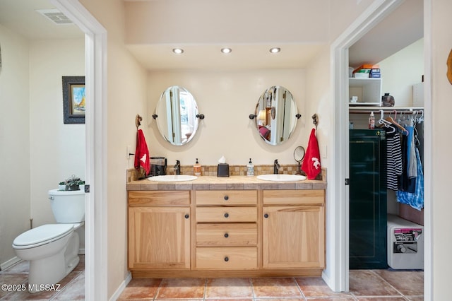 bathroom featuring toilet and vanity