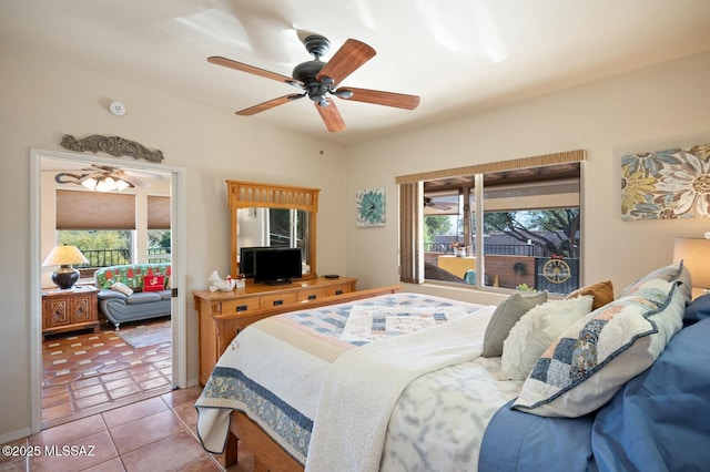 tiled bedroom featuring ceiling fan and multiple windows