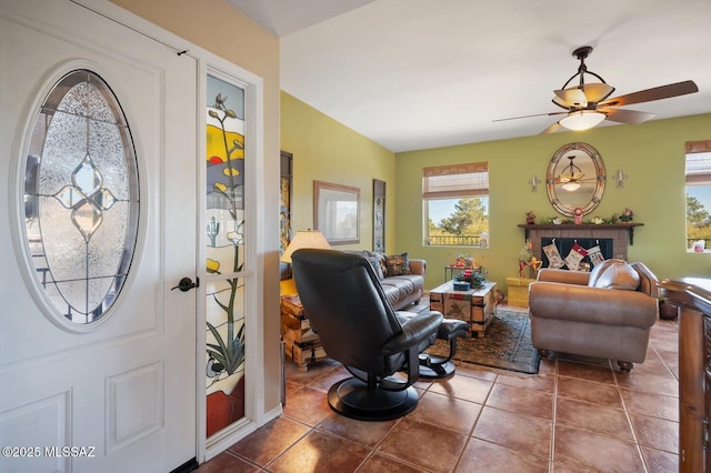 tiled living room with ceiling fan