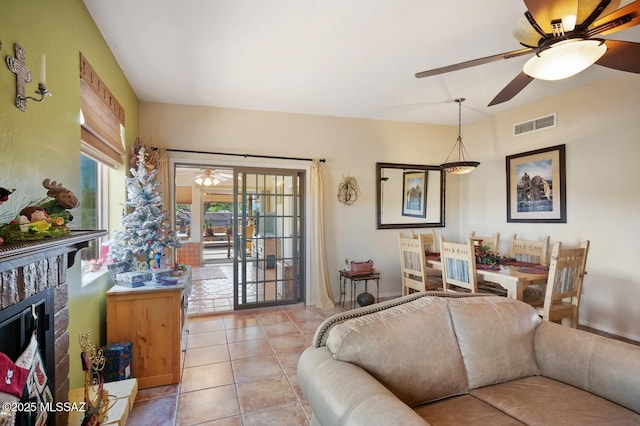 tiled living room featuring ceiling fan