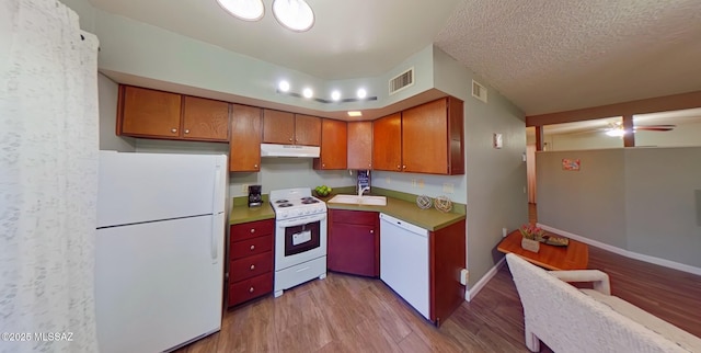 kitchen featuring a textured ceiling, ceiling fan, light hardwood / wood-style floors, and white appliances