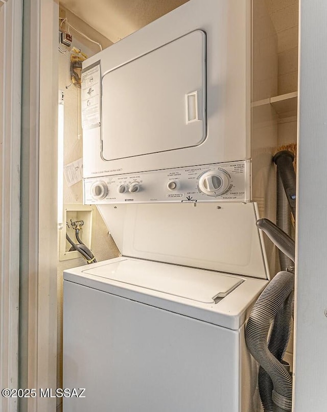 clothes washing area with stacked washer / drying machine