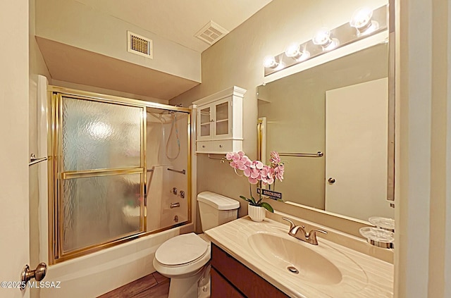 full bathroom with toilet, vanity, and combined bath / shower with glass door