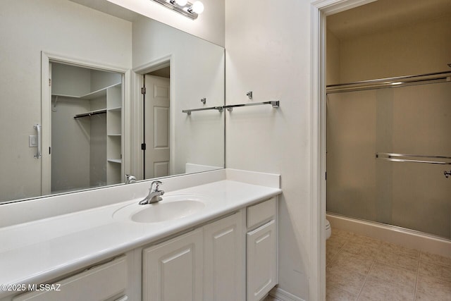 bathroom with vanity, toilet, and an enclosed shower