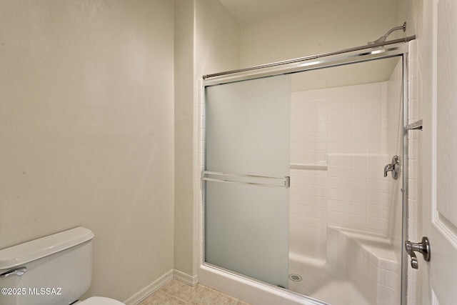 bathroom featuring toilet and walk in shower