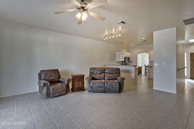 interior space with ceiling fan