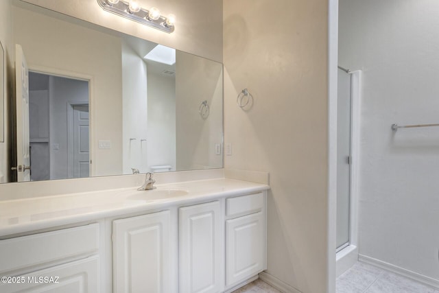 bathroom featuring vanity, tile patterned floors, and a shower with shower door