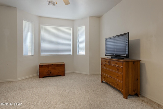 carpeted bedroom featuring ceiling fan and multiple windows