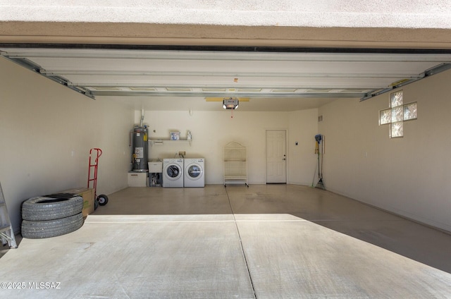 garage with separate washer and dryer, water heater, and a garage door opener