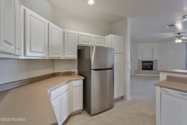 kitchen with stainless steel refrigerator, dishwasher, and white cabinets