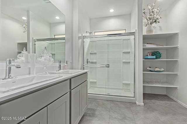 bathroom with tile patterned flooring, vanity, and walk in shower